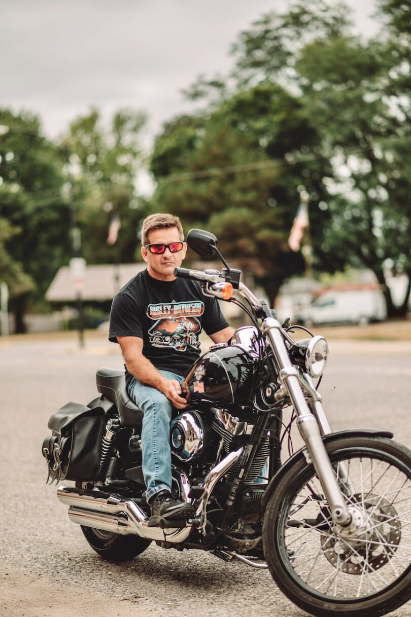 man in sunglasses sitting on a motorcycle