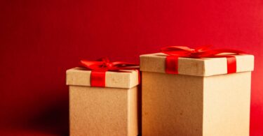 two brown and red gift boxes on red surface