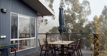 outdoor wooden table outside house in nature