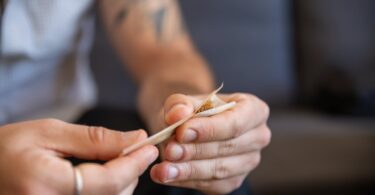 a person rolling a joint