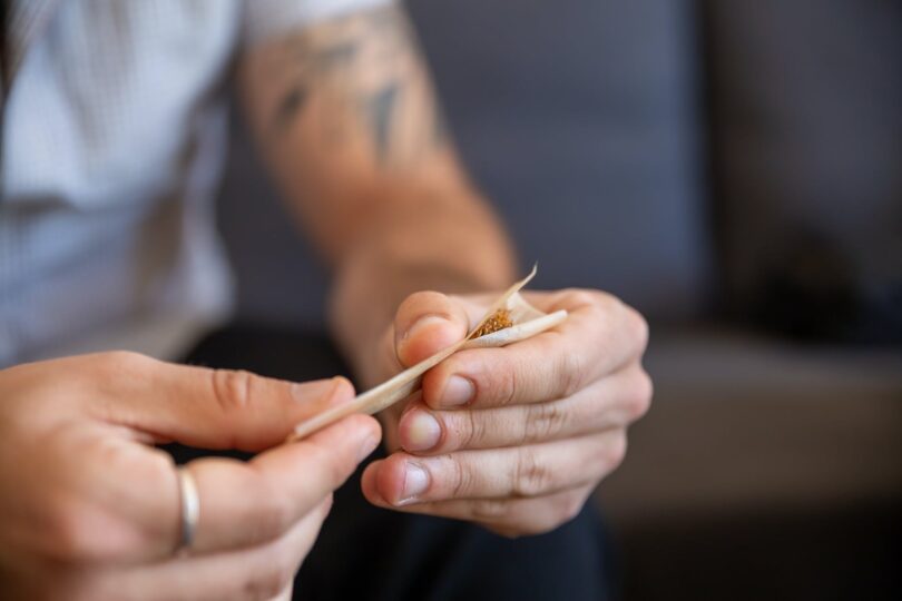 a person rolling a joint