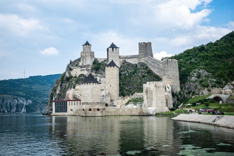 gray concrete castle beside body of water
