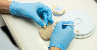 crop faceless master making dental implants