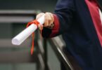 person holding white scroll
