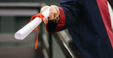 person holding white scroll